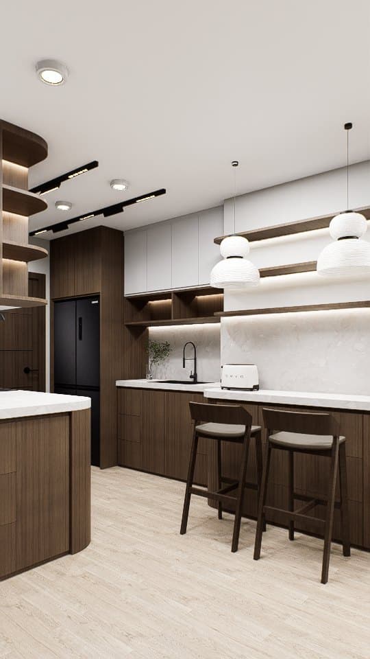A galley kitchen with quartz counters, concealed tall storage and warm overhead lighting.