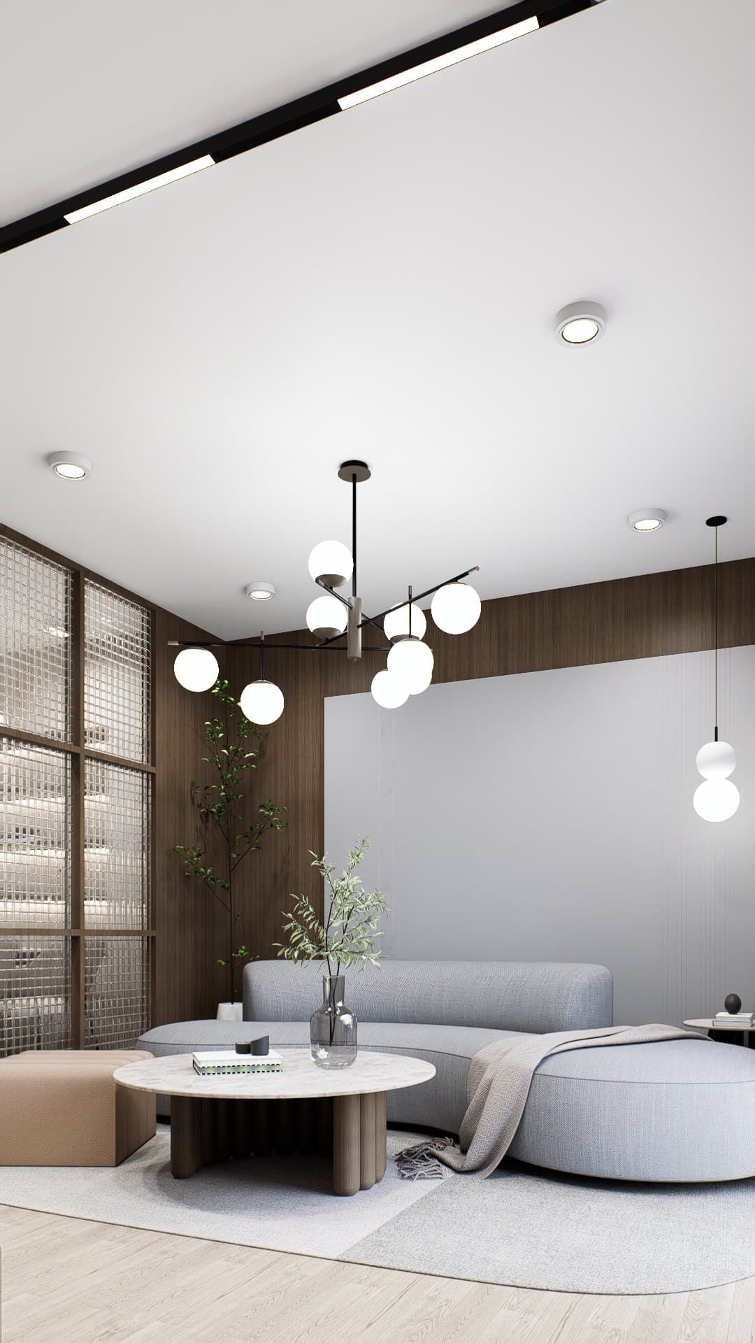 A living room framed by a feature wall and curved seating, with soft cove lighting overhead.