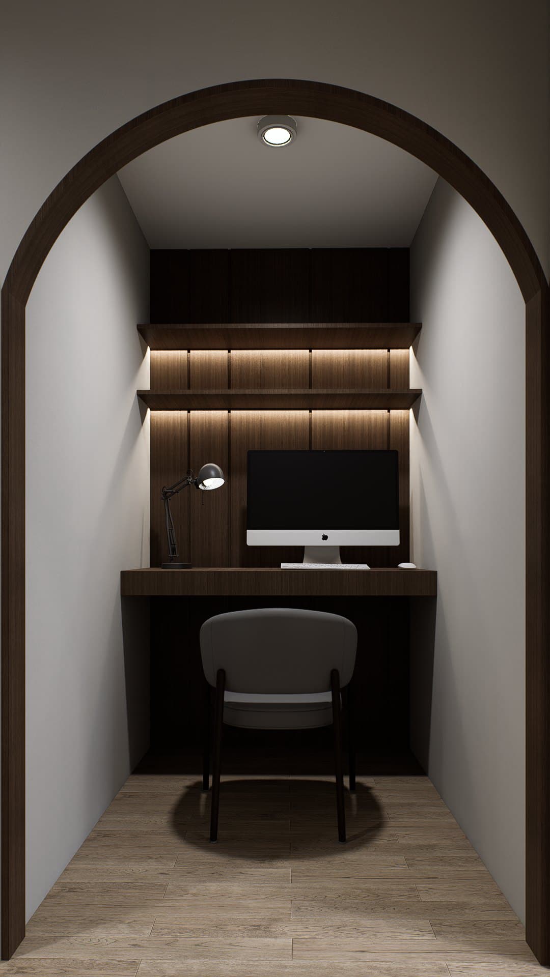A study setting with a built-in oak desk, brass-arm lamp and tonal wall panelling.
