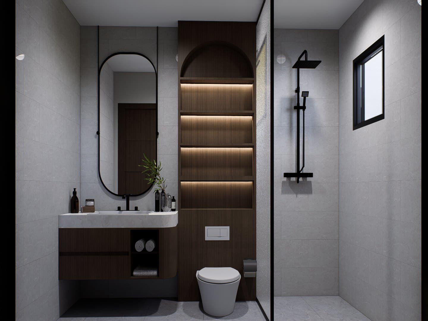 A bathroom in tonal tile, finished with a wall-hung vanity, glass shower screen and warm overhead lighting.