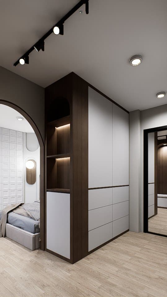 A walk-in closet lined in oak veneer, with full-height wardrobe doors and a recessed dressing console.