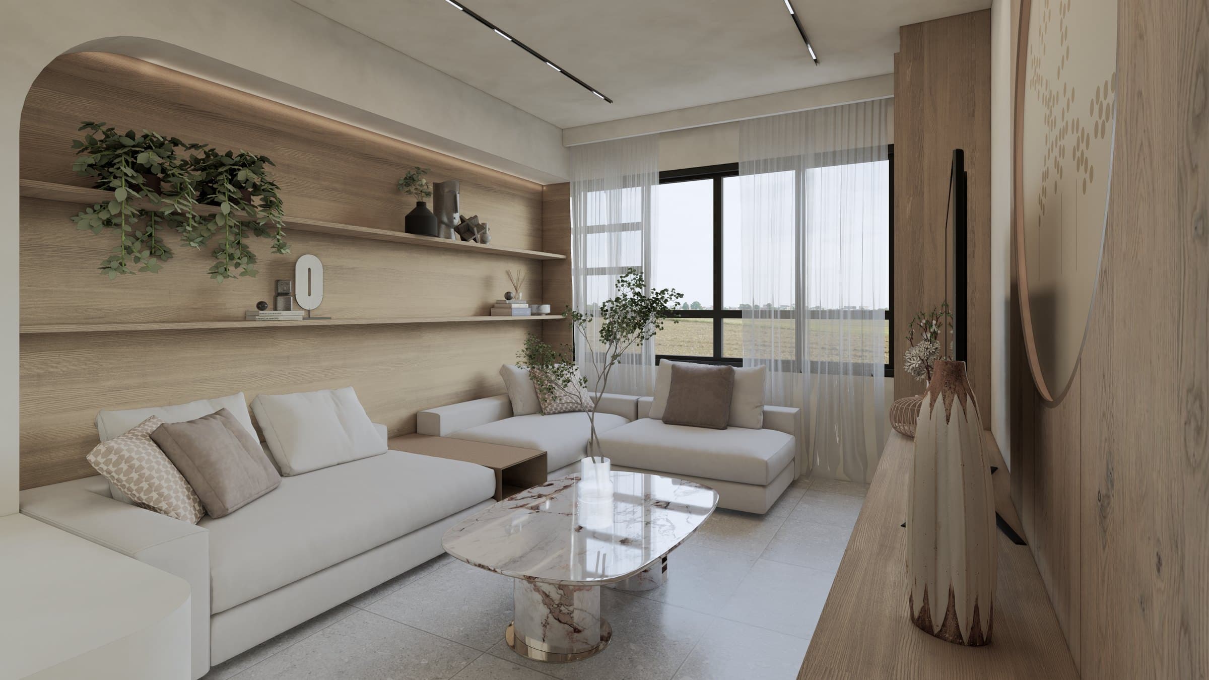 A living room arranged around a sectional sofa and feature TV wall, with cove lighting and tonal styling.