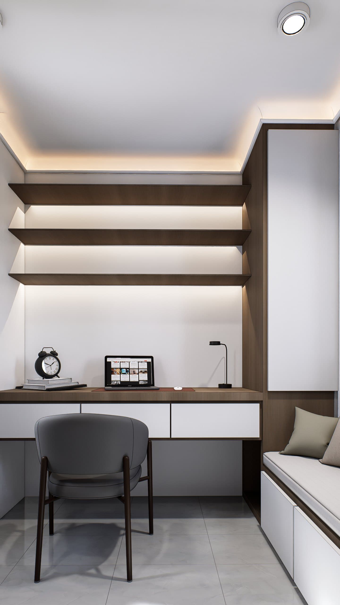 A study setting with a built-in oak desk, brass-arm lamp and tonal wall panelling.