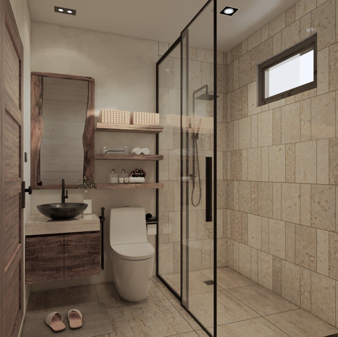 A bathroom in tonal tile, finished with a wall-hung vanity, glass shower screen and warm overhead lighting.