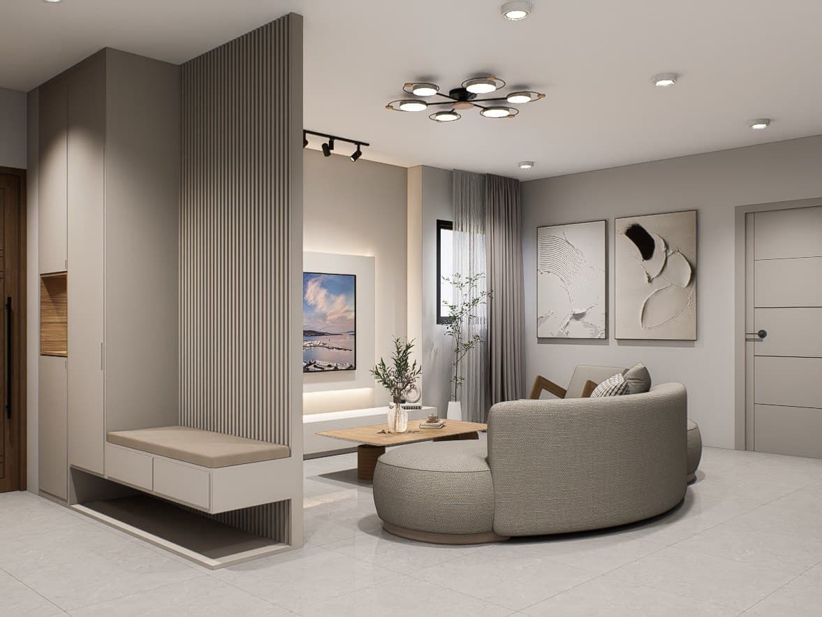 A living room framed by a feature wall and curved seating, with soft cove lighting overhead.