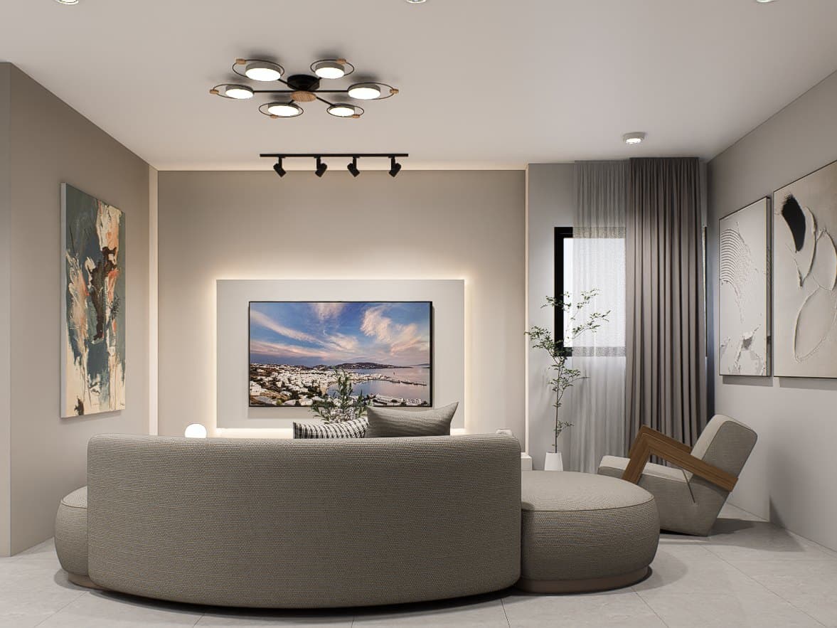 A living room framed by a feature wall and curved seating, with soft cove lighting overhead.