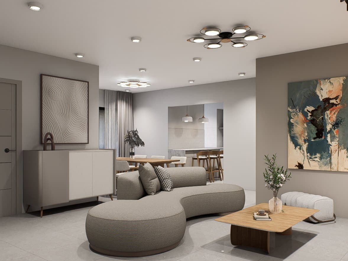 A living room framed by a feature wall and curved seating, with soft cove lighting overhead.