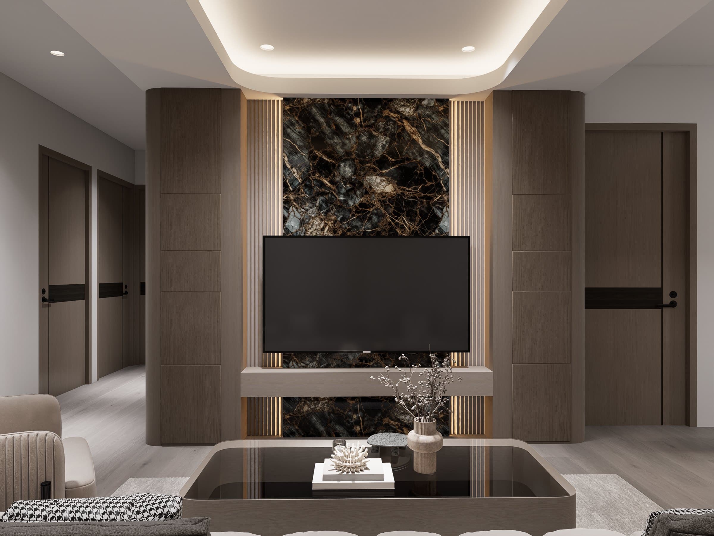A living room framed by a feature wall and curved seating, with soft cove lighting overhead.